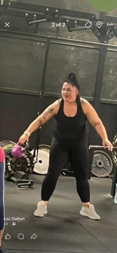 April 2025 Person lifting a dumbbell in a gym setting, wearing workout attire.